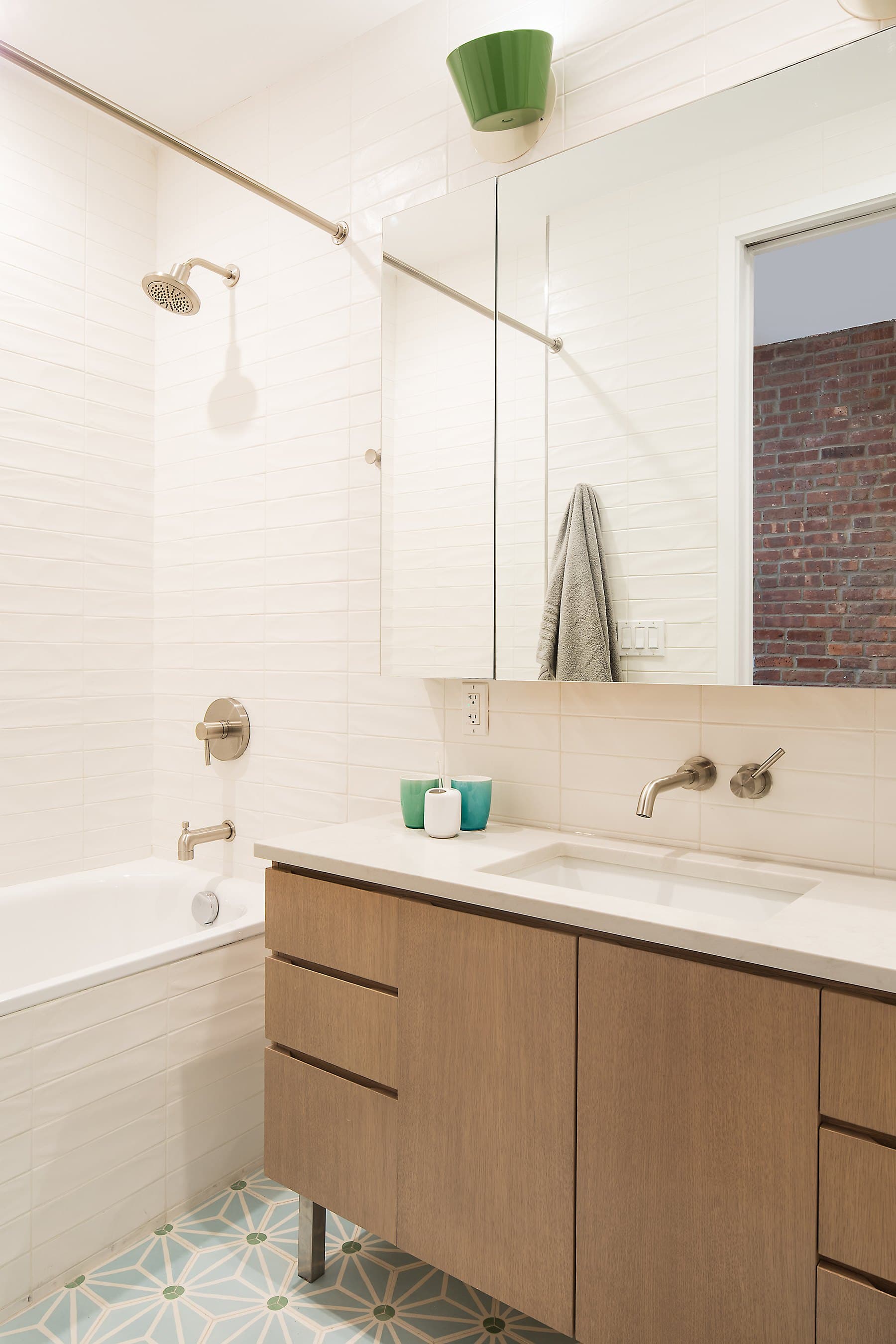 Second-floor bath with a wood vanity and a soaking tub