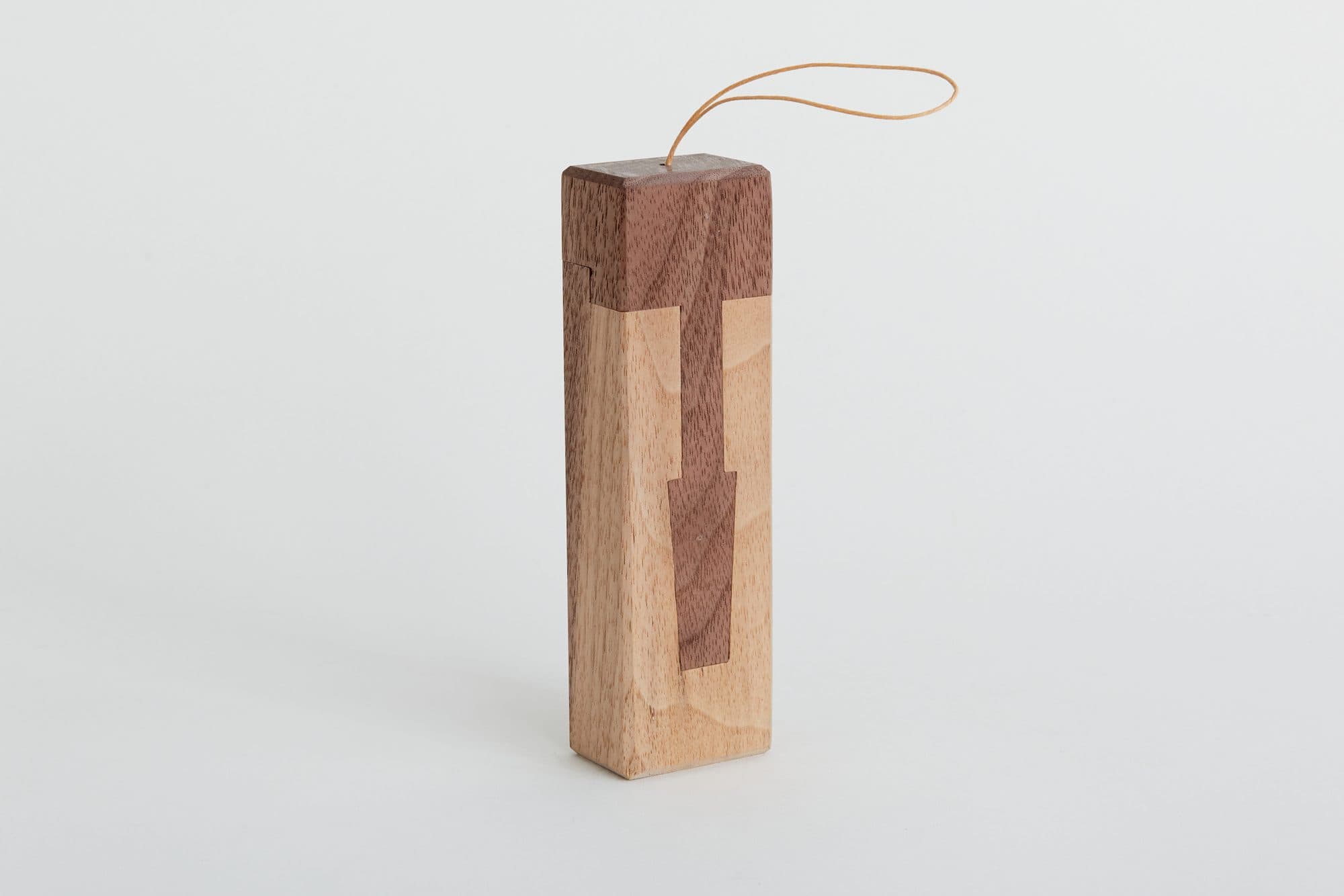 Inlaid wood block ornament on a leather loop by Base 10