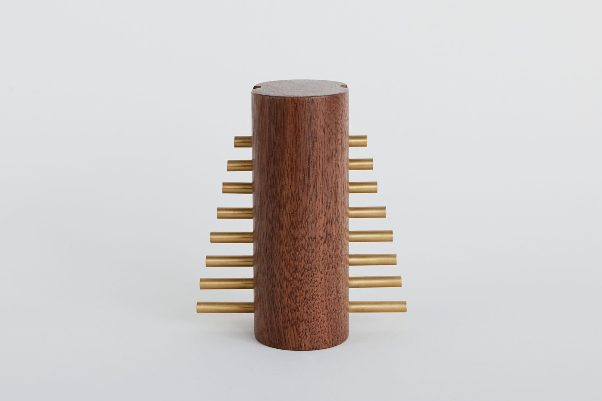 Walnut cylinder ornament with brass fins by David Gaynor