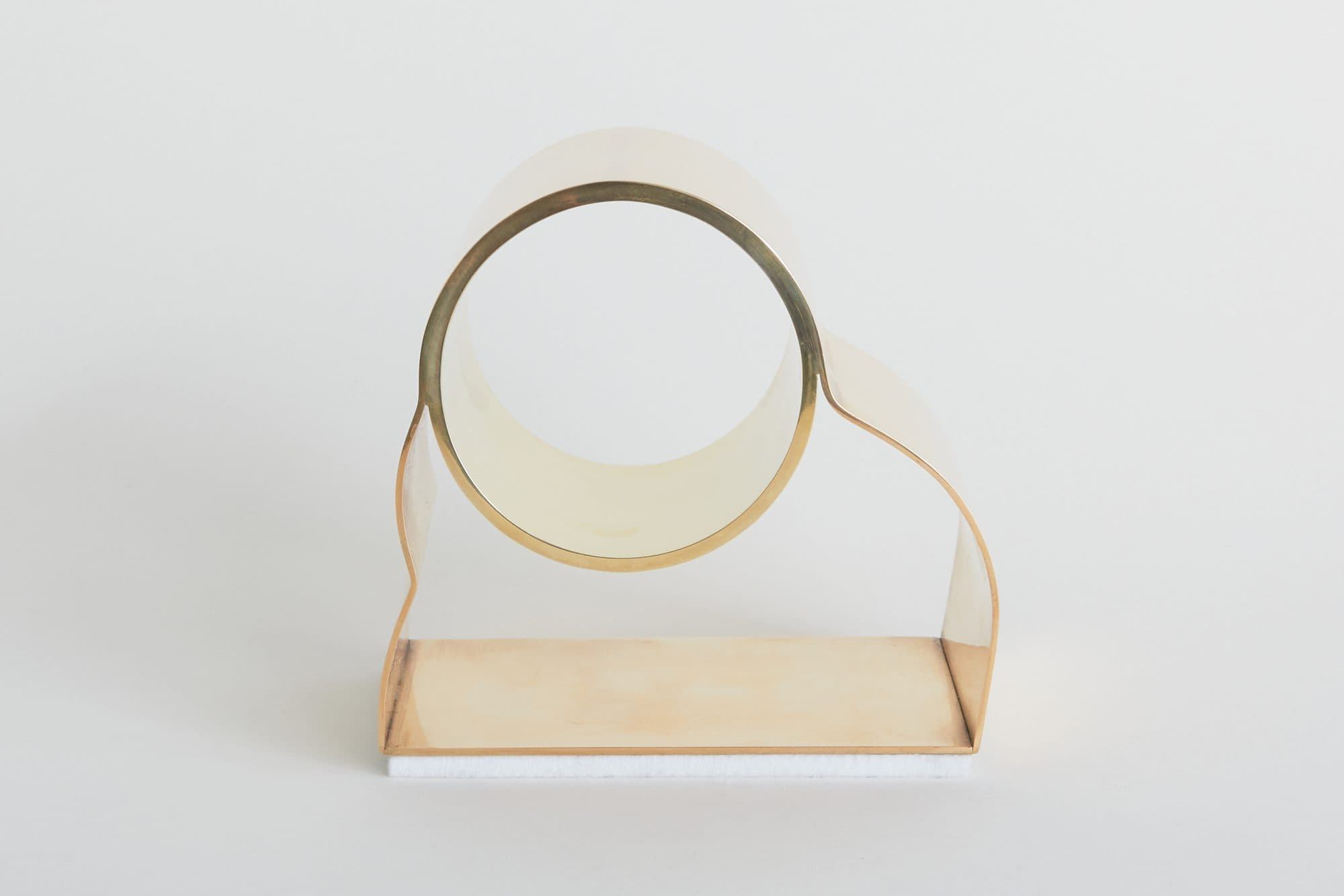 Brass ring and pale wood ornament by Evan Z. Crane