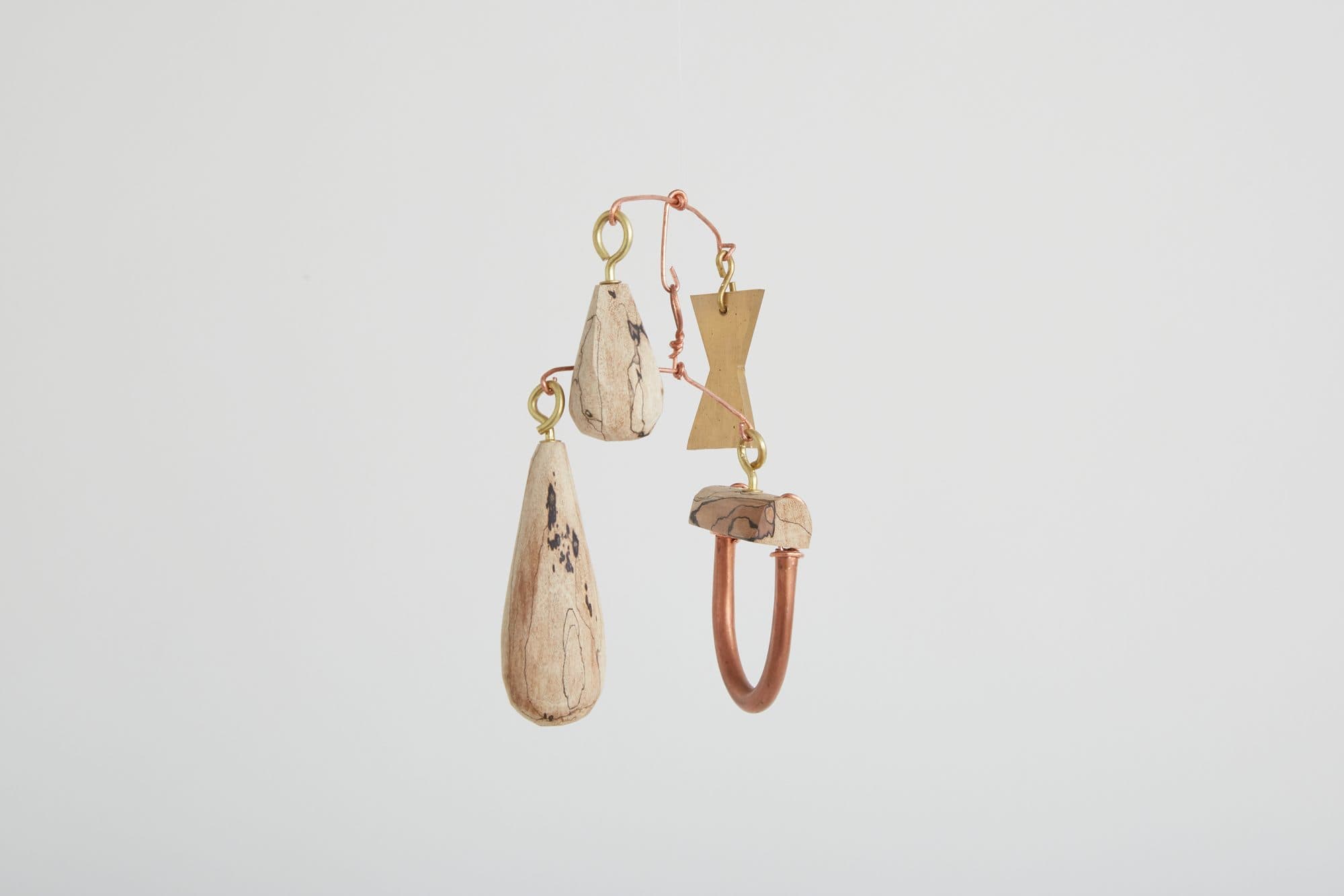 Hanging cluster of small carved forms by Greta de Parry