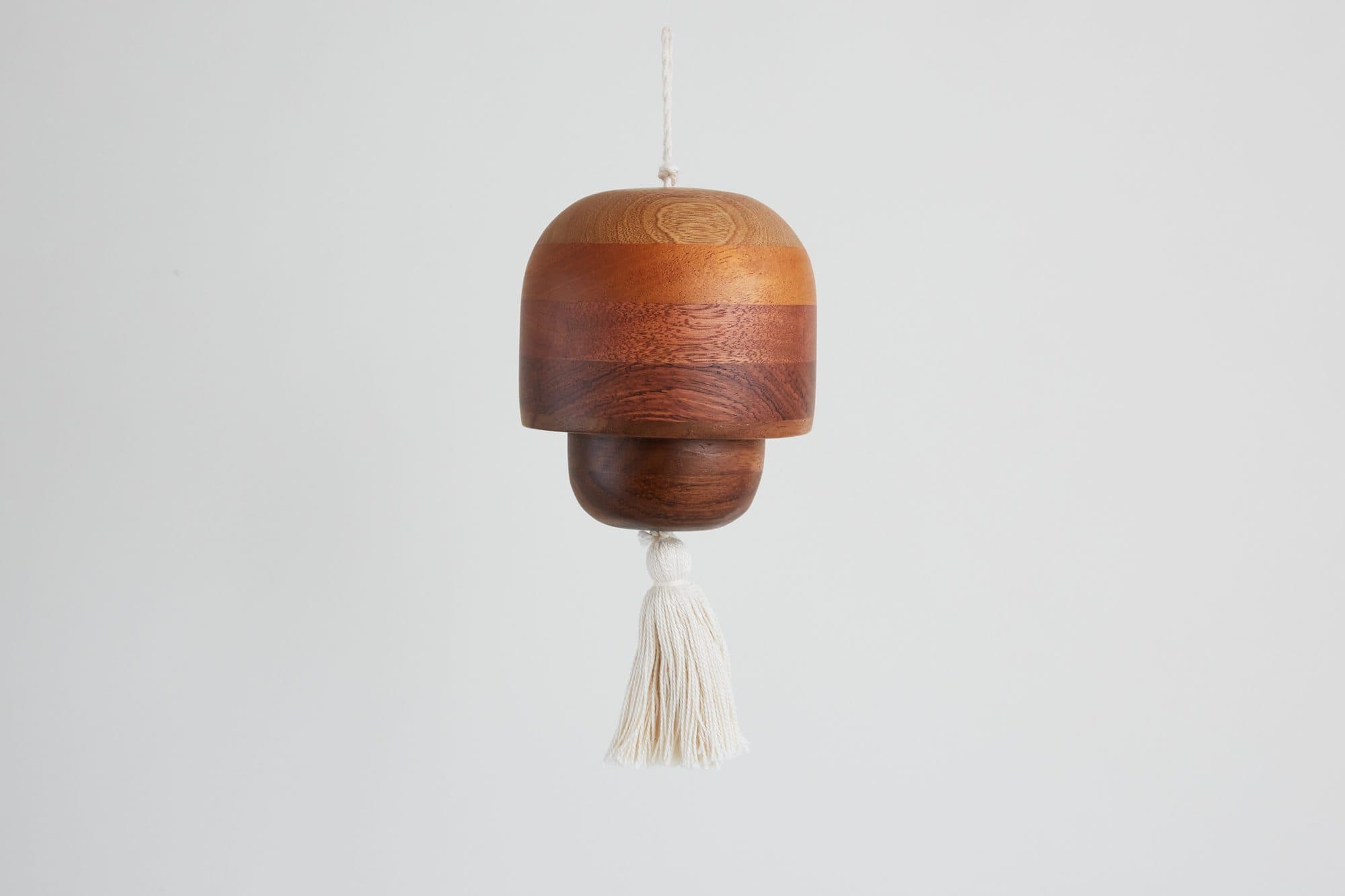 Turned wood bell ornament with a cotton tassel by Labrica