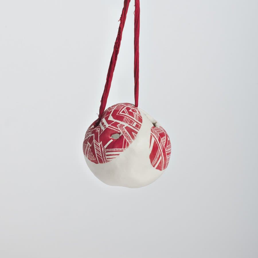 Ceramic ball wrapped in red pattern