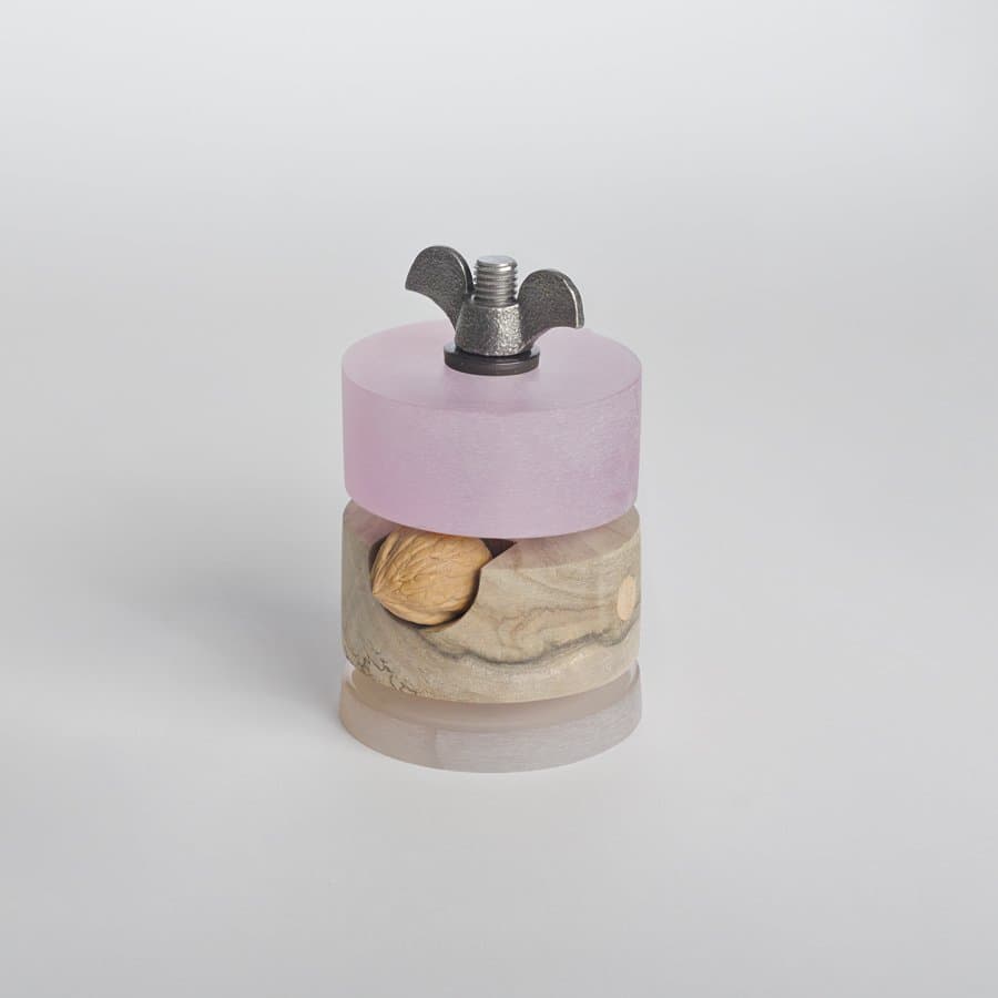 Pink resin and brass wing nut ornament by Daniel Moyer