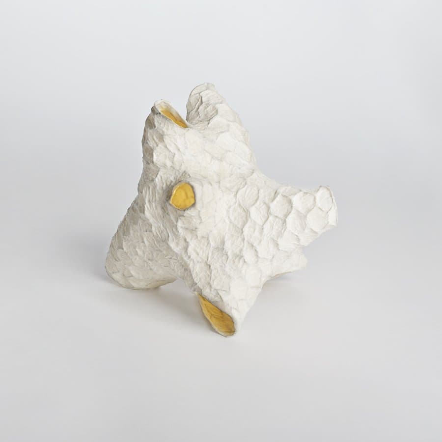 White sculpted ornament with gold accents by Patrick Weder