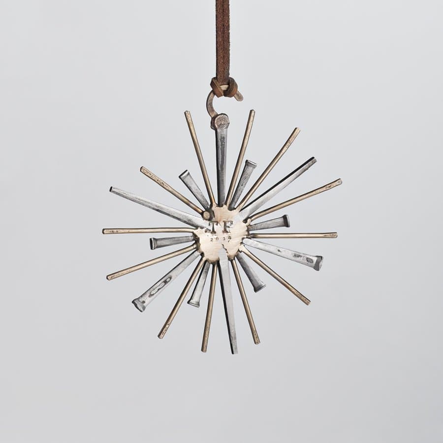 Starburst of metal rods on a leather loop by Taylor Forrest