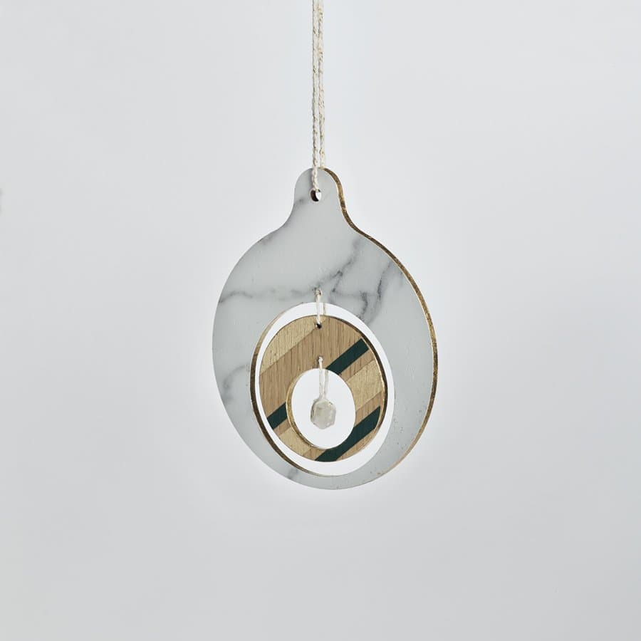 Marble disc ornament with a brass ring by Volk