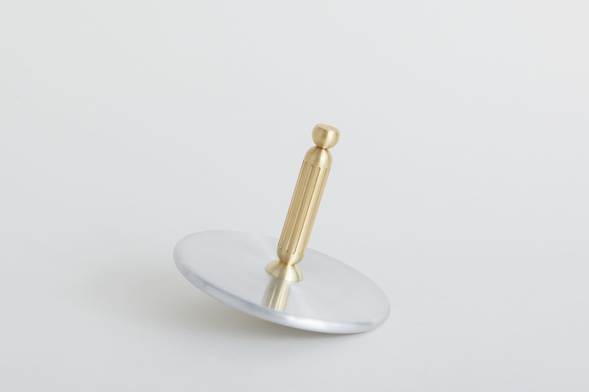 Spinning top of a brass stem on an aluminum disc by Taylor Forrest