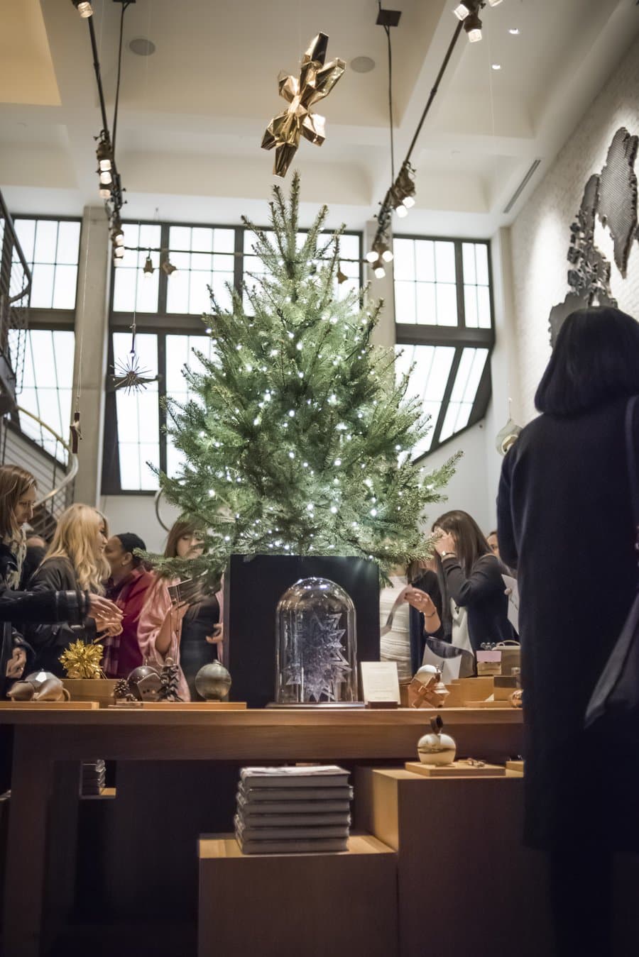 Spruce under the skylights of the Shinola TriBeCa store, ringed by ornament displays