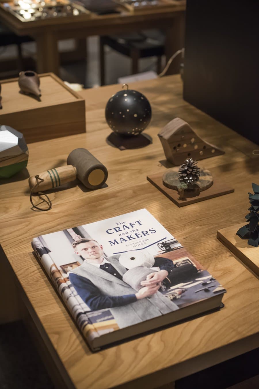 Ornaments and a book on a wood table at the Shinola tree lighting