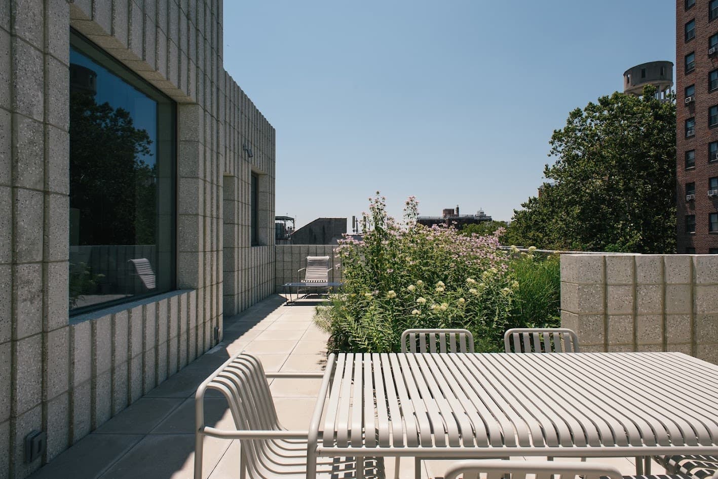 450 Warren terrace with white slatted furniture, wildflowers and a Brooklyn water tower beyond