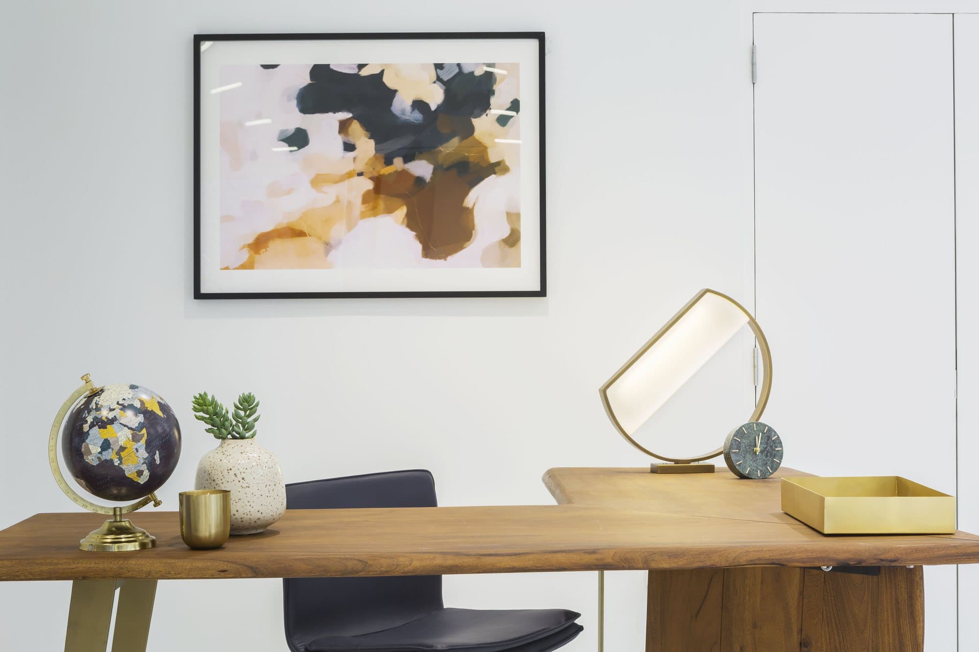 Walnut desk with a globe and a brass mirror