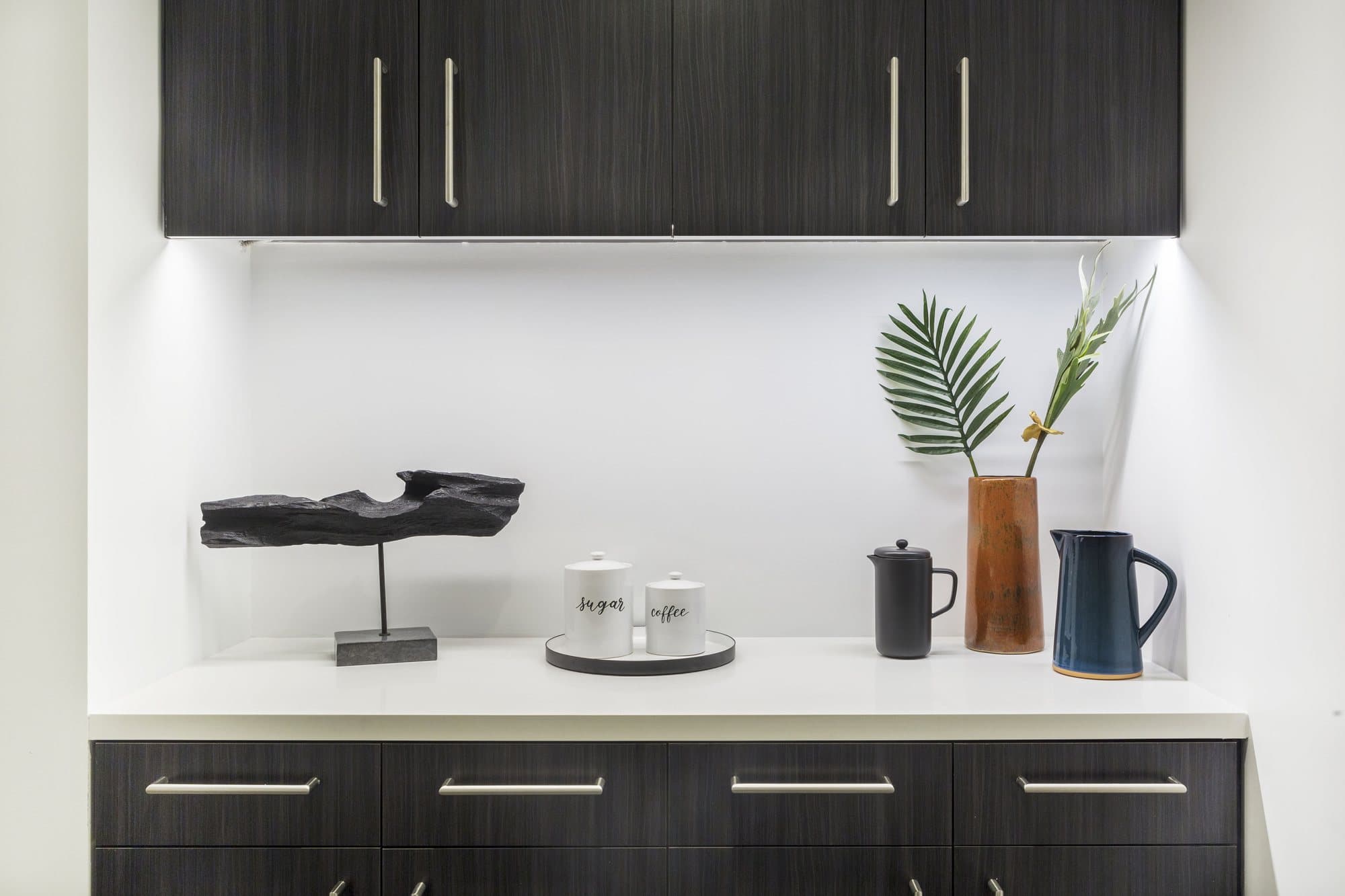 Kitchen counter with a sculpture and plants