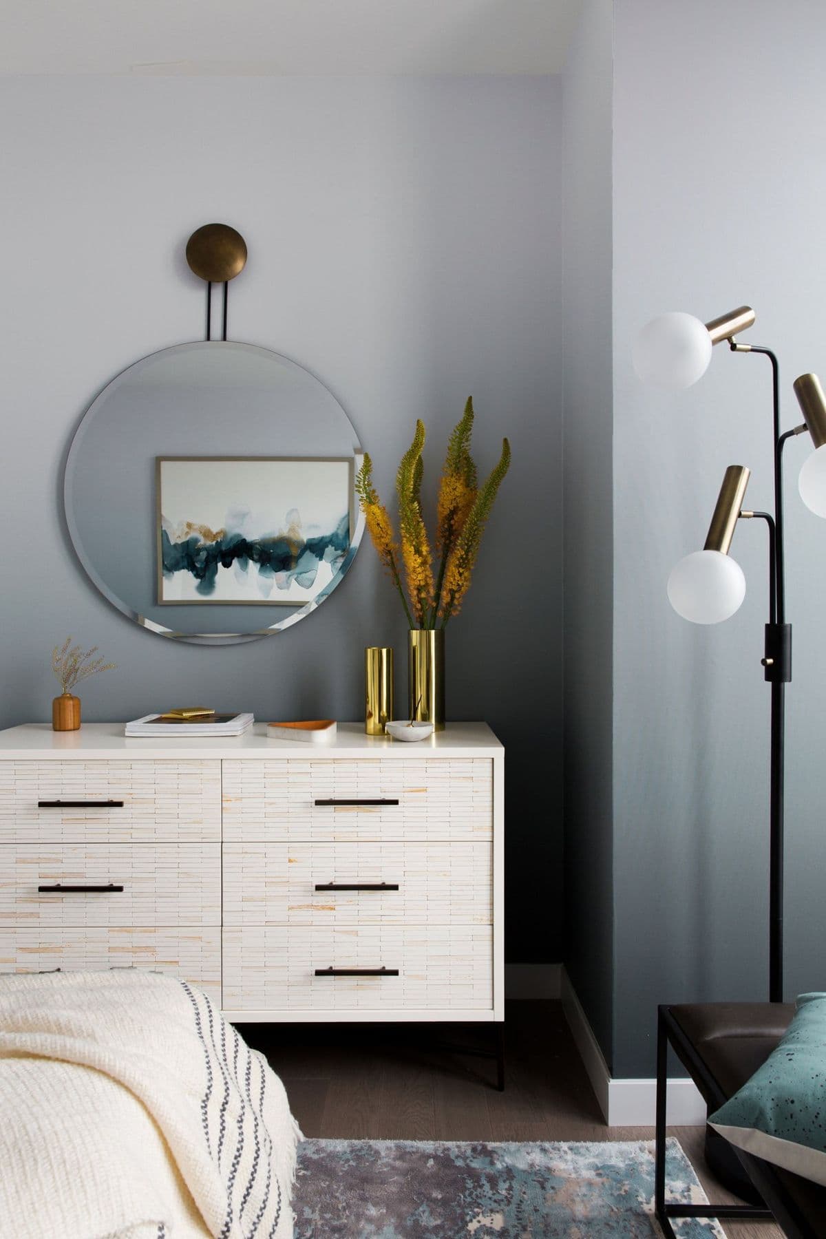 Craig Hill credenza under a round mirror against a grey ombre wall