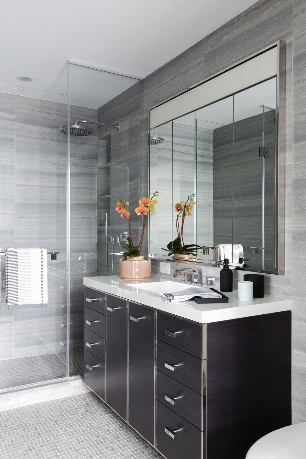 Bathroom with a black vanity and grey stone