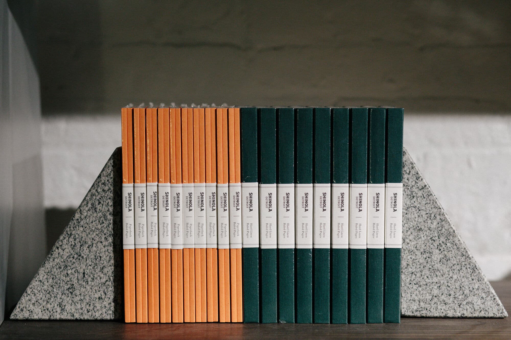 Shinola journals held between granite bookends on a shelf